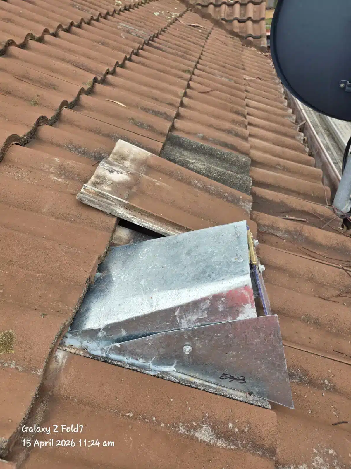 One-way possum door fitted mid roof on terracotta tiles